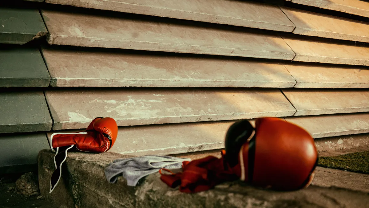 Boxing gloves on stone steps in warm sunlight